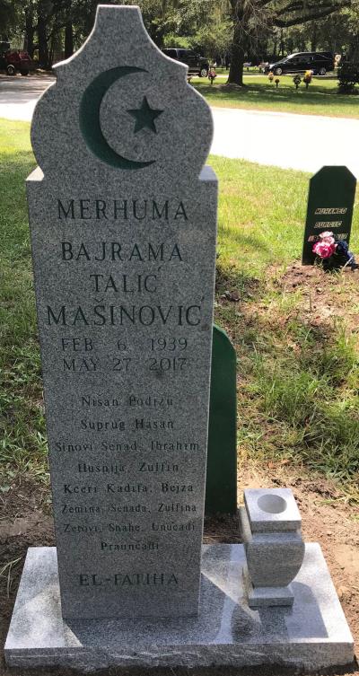 individual granite headstone with crescent moon design and a flower vase